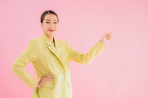 Portrait beautiful young asian business woman smile in action on pink color