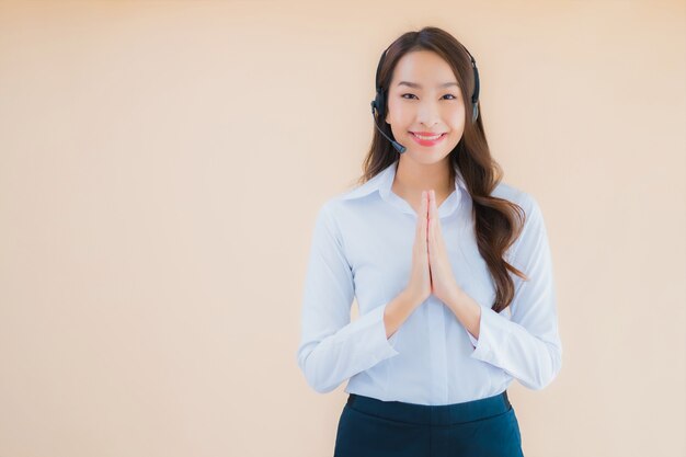 Portrait beautiful young asian business woman with headphone for call center