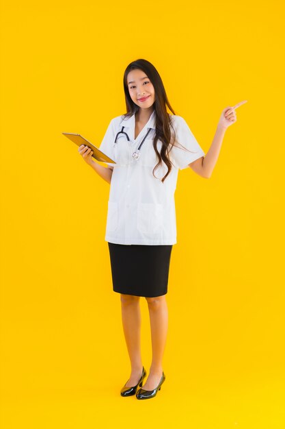 Portrait of beautiful young asian doctor woman uses smart tablet device