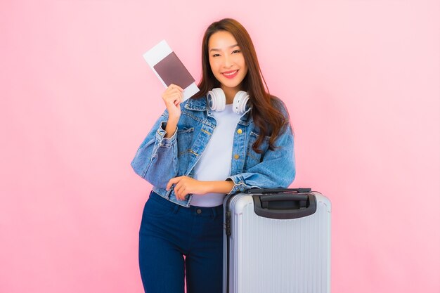 Portrait beautiful young asian woman backpack ready for travel in vacation on pink wall