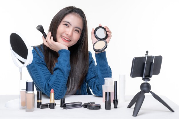 Free Photo portrait of beautiful young asian woman beauty vlogger making make-up looking in the camera  blogger recording and streaming video to share on social media