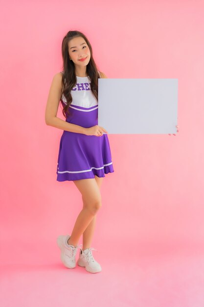 Portrait beautiful young asian woman cheerleader smile show empty white board