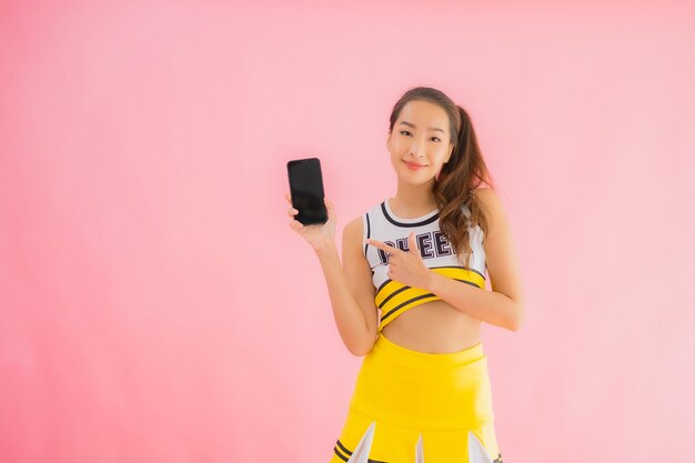 Portrait beautiful young asian woman cheerleader with smart mobile phone