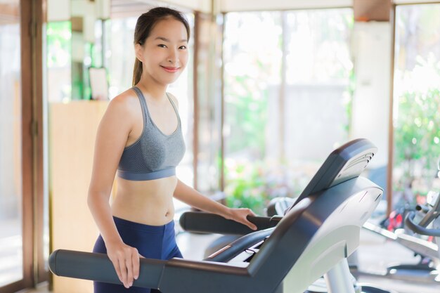 Portrait beautiful young asian woman exercise with fitness equipment in gym interior