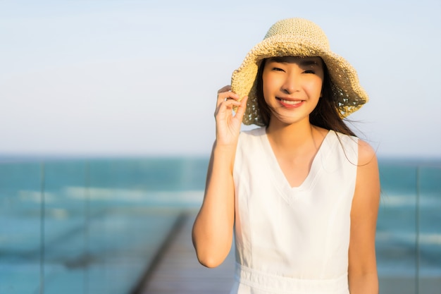 Portrait beautiful young asian woman happy and smile on the beach sea and ocean