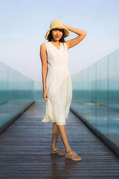 Portrait beautiful young asian woman happy and smile on the beach sea and ocean