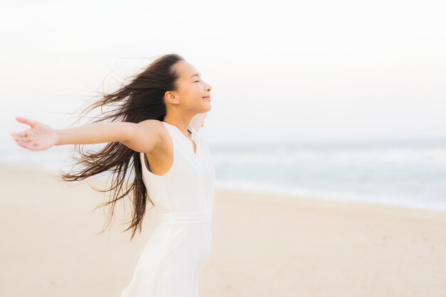 Portrait beautiful young asian woman happy and smile on the beach sea and ocean