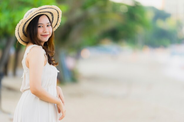 Portrait beautiful young asian woman happy and smile on the beach sea and ocean