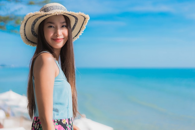 Portrait beautiful young asian woman happy smile relax around beach ocean and sea