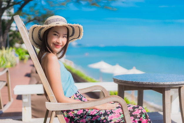 Portrait beautiful young asian woman happy smile relax around beach ocean and sea