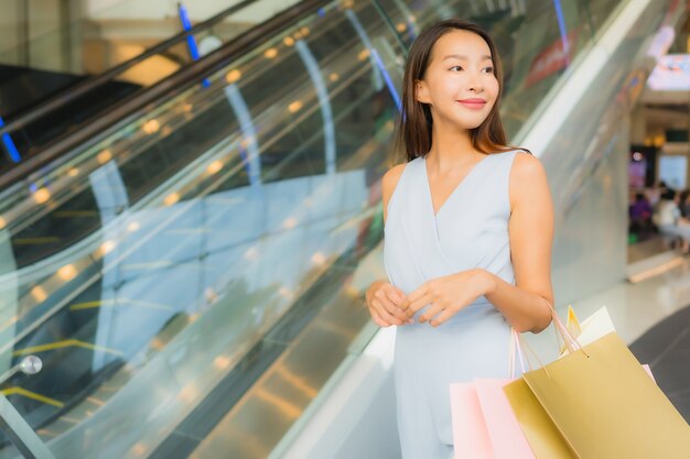 Portrait beautiful young asian woman happy and smile with shopping bag from department store