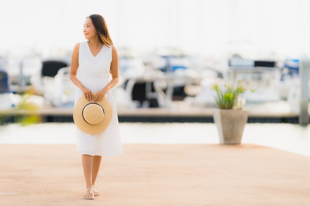 Portrait beautiful young asian woman leisure smile happy relax around yacht port