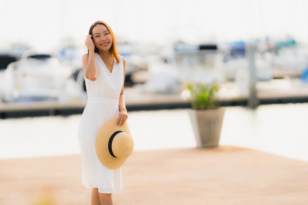 Portrait beautiful young asian woman leisure smile happy relax around yacht port