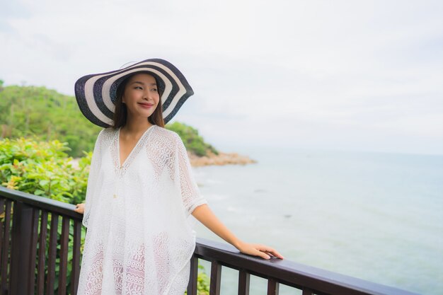 Portrait beautiful young asian woman looking sea beach ocean for relax in holiday vacation travel