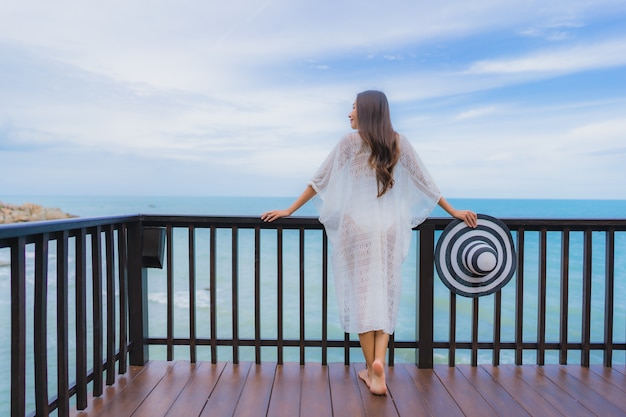 Portrait beautiful young asian woman looking sea beach ocean for relax in holiday vacation travel