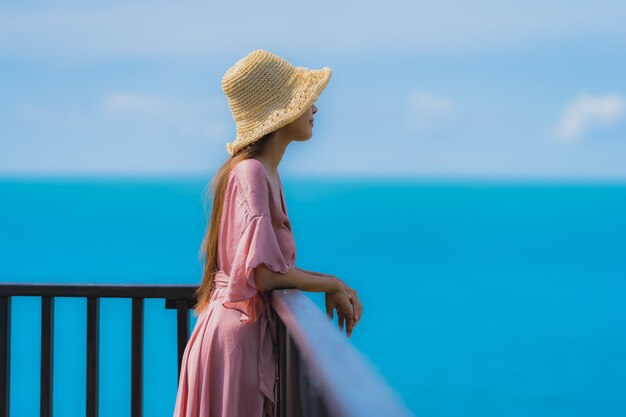 Portrait beautiful young asian woman looking sea beach ocean for relax in holiday vacation travel