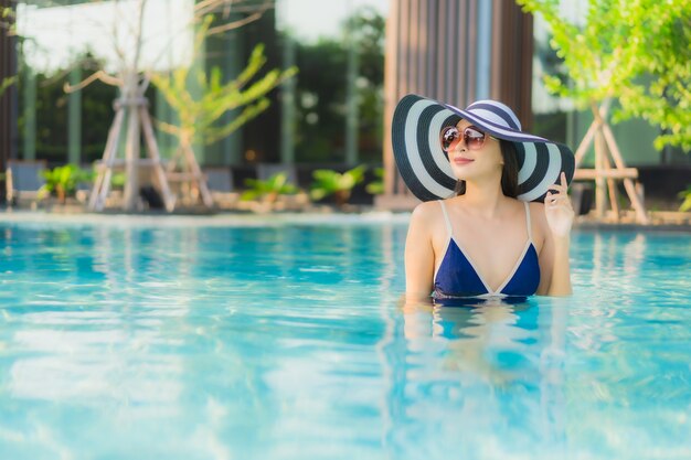 Portrait beautiful young asian woman relax around swimming pool in hotel resort