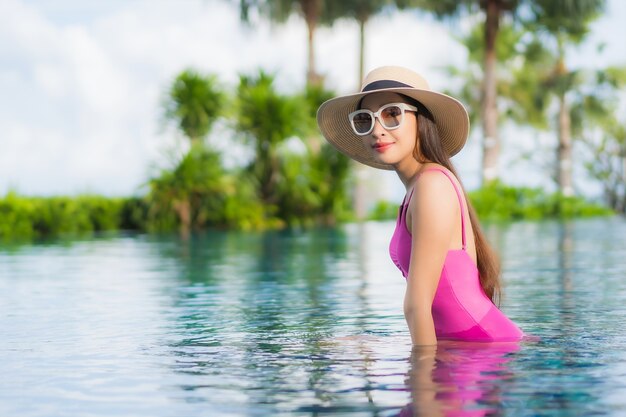 Portrait beautiful young asian woman relax enjoy around outdoor swimming pool in holiday vacation