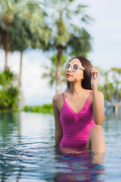 Portrait beautiful young asian woman relax enjoy around outdoor swimming pool in holiday vacation