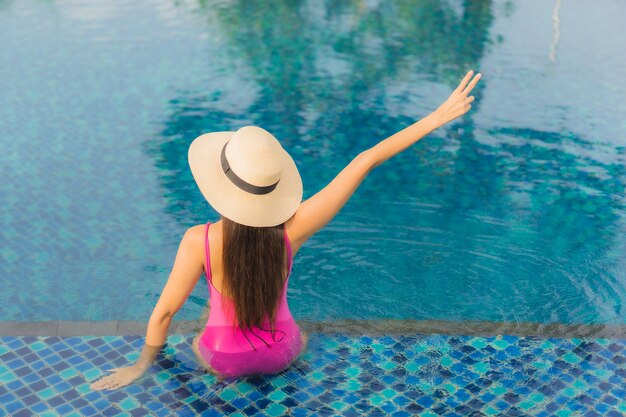 Portrait beautiful young asian woman relax enjoy around outdoor swimming pool in holiday vacation