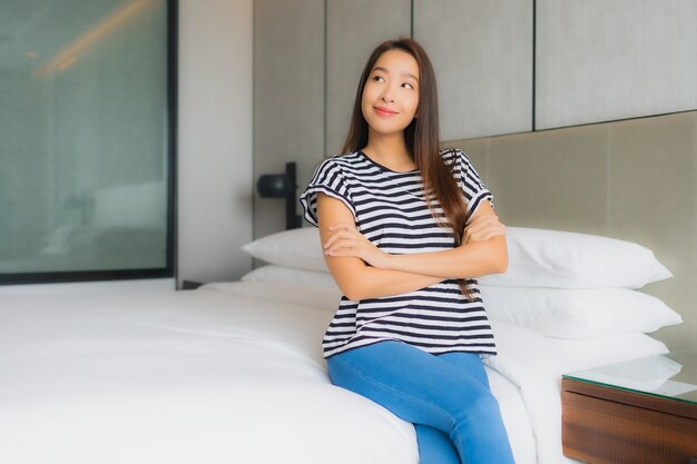 Portrait beautiful young asian woman relax happy smile in bedroom