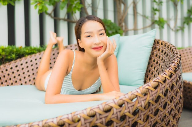 Portrait beautiful young asian woman relax leisure around outdoor swimming pool in hotel resort for travel vacation