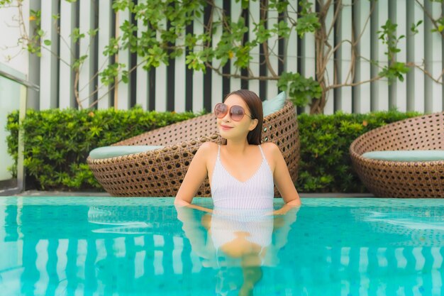 Portrait beautiful young asian woman relax leisure around outdoor swimming pool in hotel resort for travel vacation