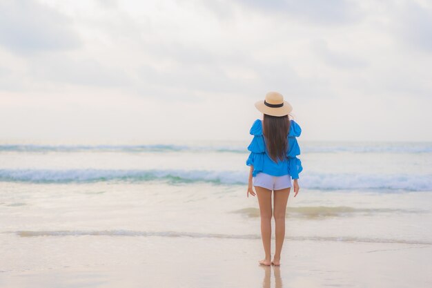 Portrait beautiful young asian woman relax leisure smile around beach sea ocean at sunset time