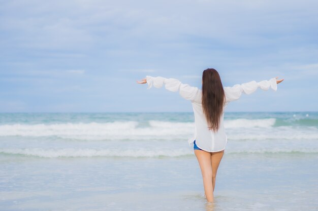 Portrait beautiful young asian woman relax smile around beach sea ocean in holiday vacation travel trip