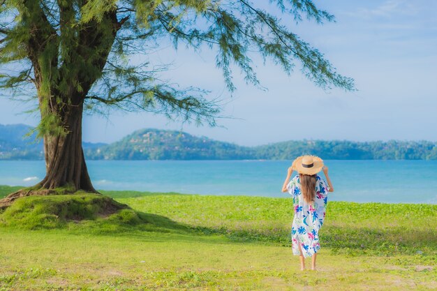 Portrait beautiful young asian woman relax smile around beach sea ocean in holiday vacation