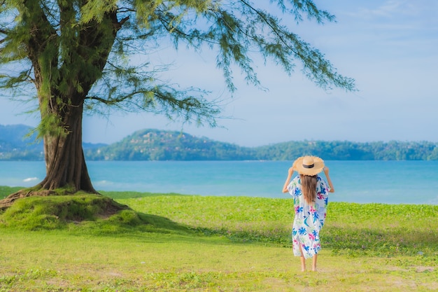 Portrait beautiful young asian woman relax smile around beach sea ocean in holiday vacation