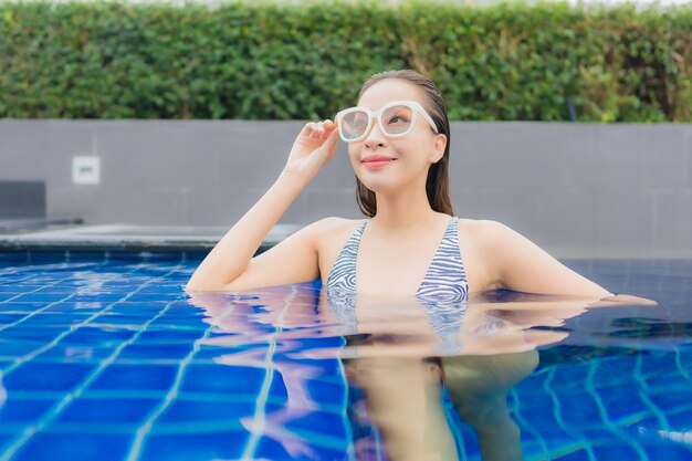 Portrait beautiful young asian woman relax smile around outdoor swimming pool