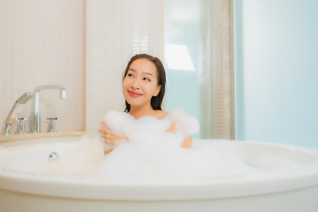 Portrait beautiful young asian woman relax smile in bathtub at bathroom interior