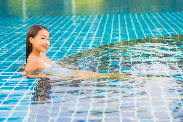 Portrait beautiful young asian woman relax smile leisure around outdoor swimming pool nearly sea