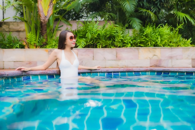 Portrait beautiful young asian woman relax smile leisure around outdoor swimming pool