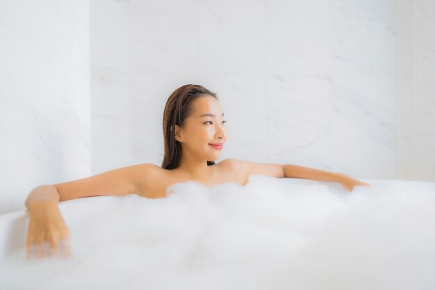 Portrait of beautiful young asian woman relaxes in bathtub