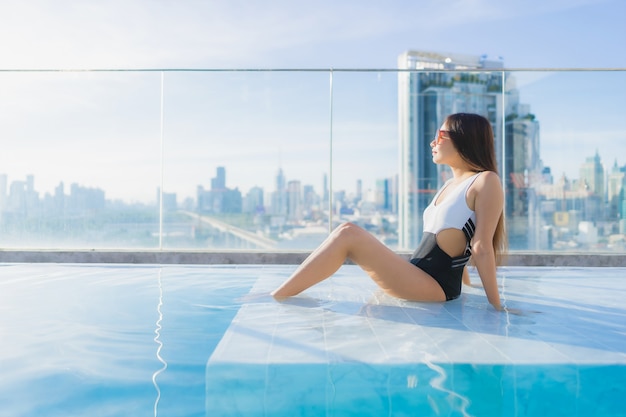 Free photo portrait beautiful young asian woman relaxes leisure around swimming pool