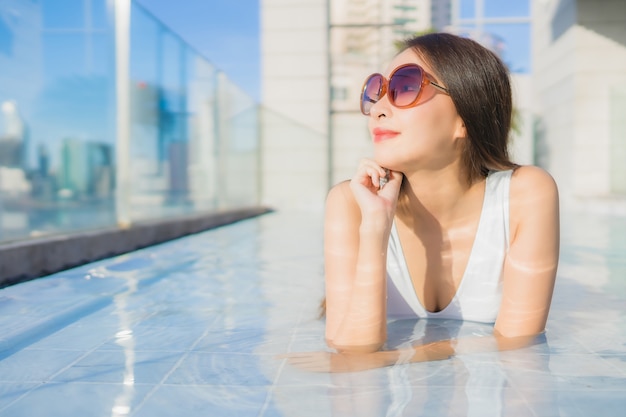 Portrait beautiful young asian woman relaxes leisure around swimming pool