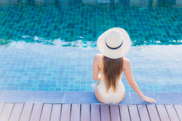 Portrait of beautiful young asian woman relaxing around outdoor swimming pool in hotel resort