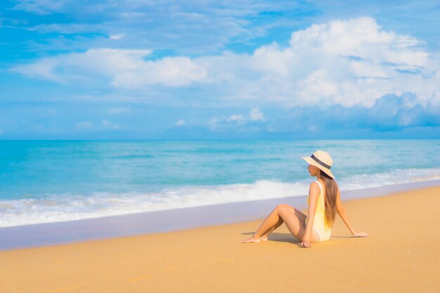 Portrait of beautiful young asian woman relaxing in the beach in travel vacation