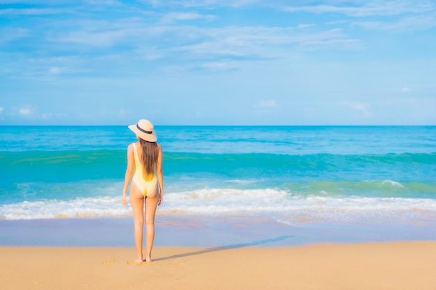 Portrait of beautiful young asian woman relaxing in the beach in travel vacation