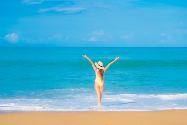 Portrait of beautiful young asian woman relaxing in the beach in travel vacation