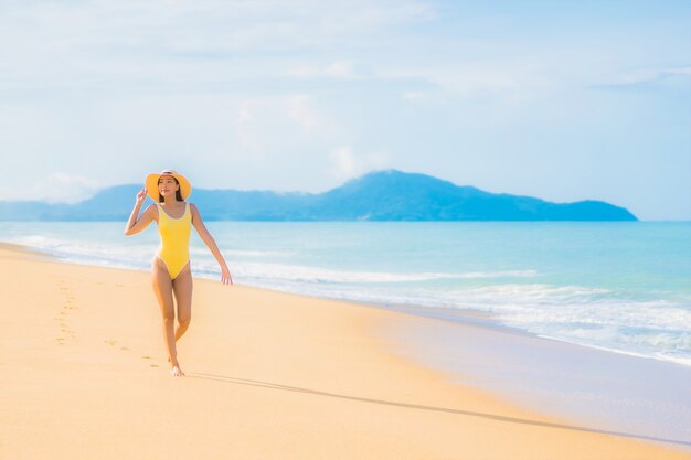 Portrait of beautiful young asian woman relaxing in the beach in travel vacation