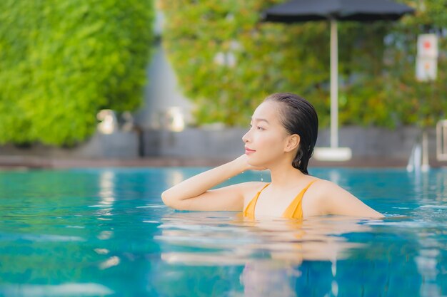 Portrait beautiful young asian woman relaxing outdoor in swimming pool in holiday trip