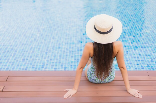 Portrait beautiful young asian woman relaxing outdoor in swimming pool in holiday trip