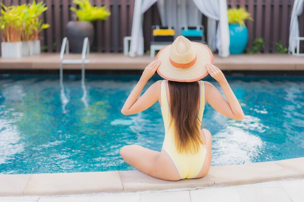 Portrait beautiful young asian woman relaxing outdoor in swimming pool in holiday trip