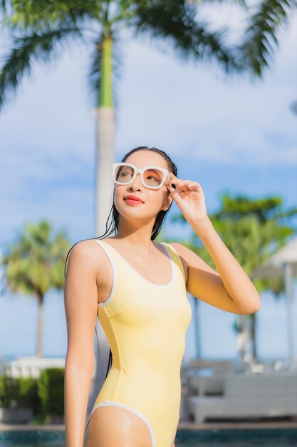 Portrait beautiful young asian woman relaxing outdoor in swimming pool in holiday trip