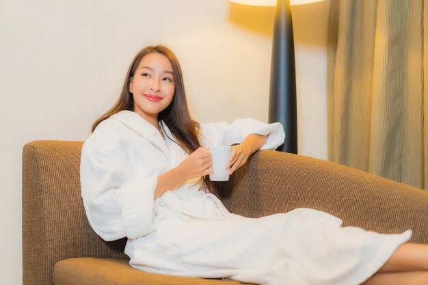 Portrait beautiful young asian woman relaxing on sofa in living room interior