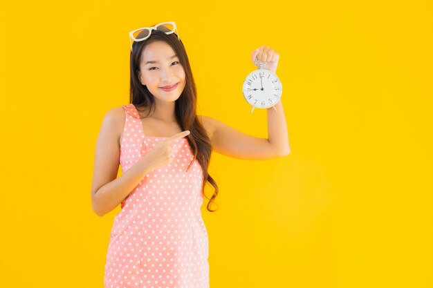 Portrait beautiful young asian woman show alarm or clock