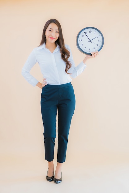 Portrait beautiful young asian woman show alarm or clock